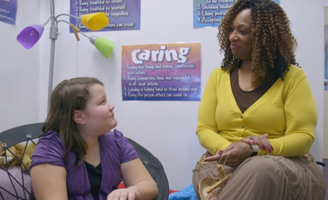 Employee mentoring a young woman